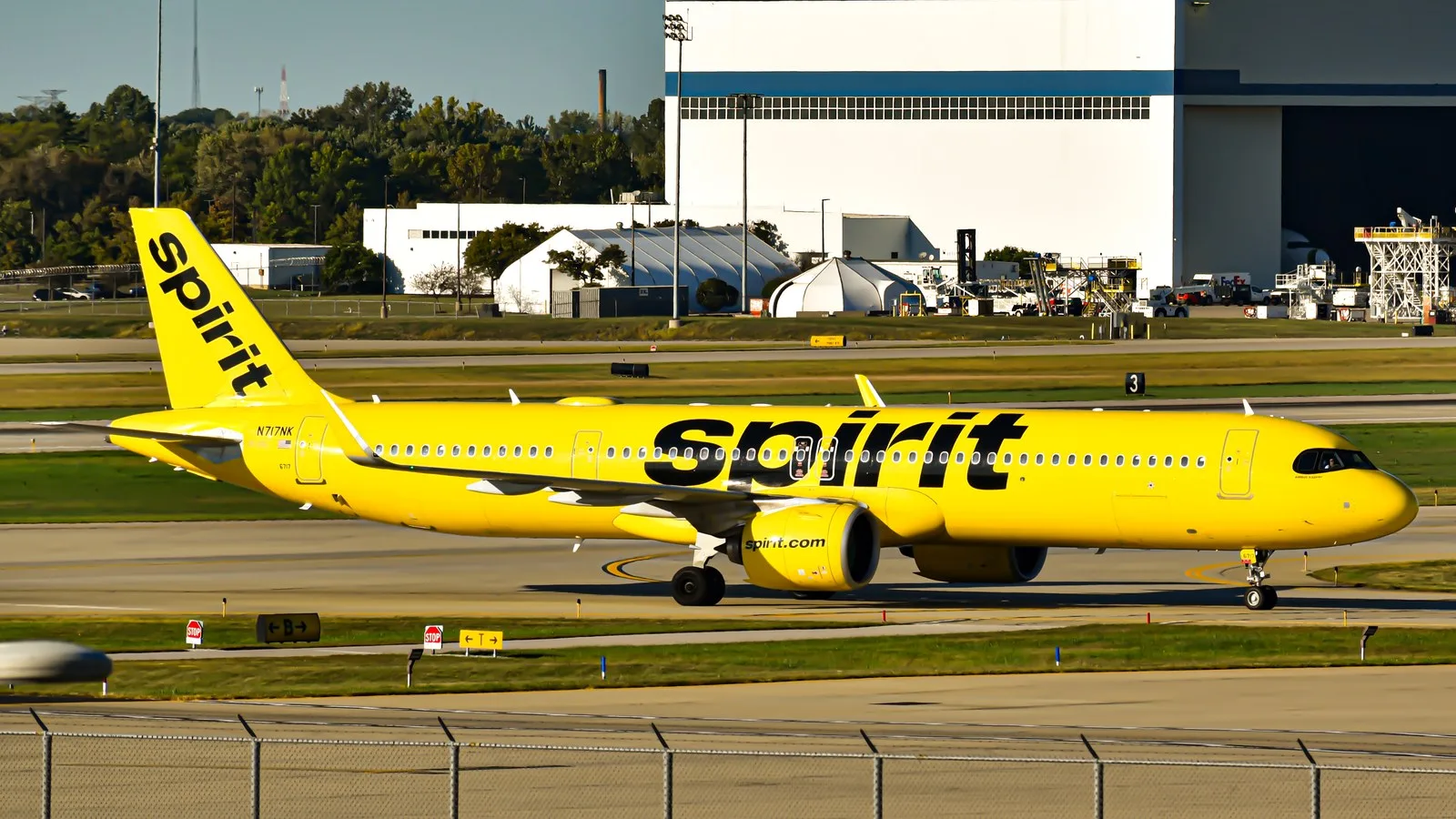 Yellow Spirit Airlines A321neo jet taxiing on an airport runway
