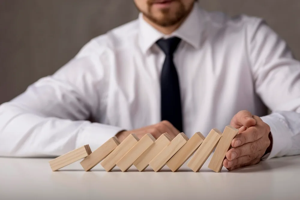 professional holding stack of falling dominos
